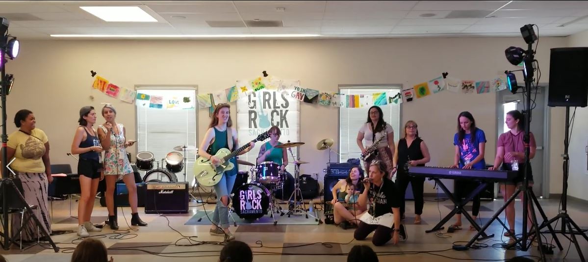 Girls playing a variety of instruments and singing in a jam session at Girls Rock Sacramento Teen Camp, July 2019