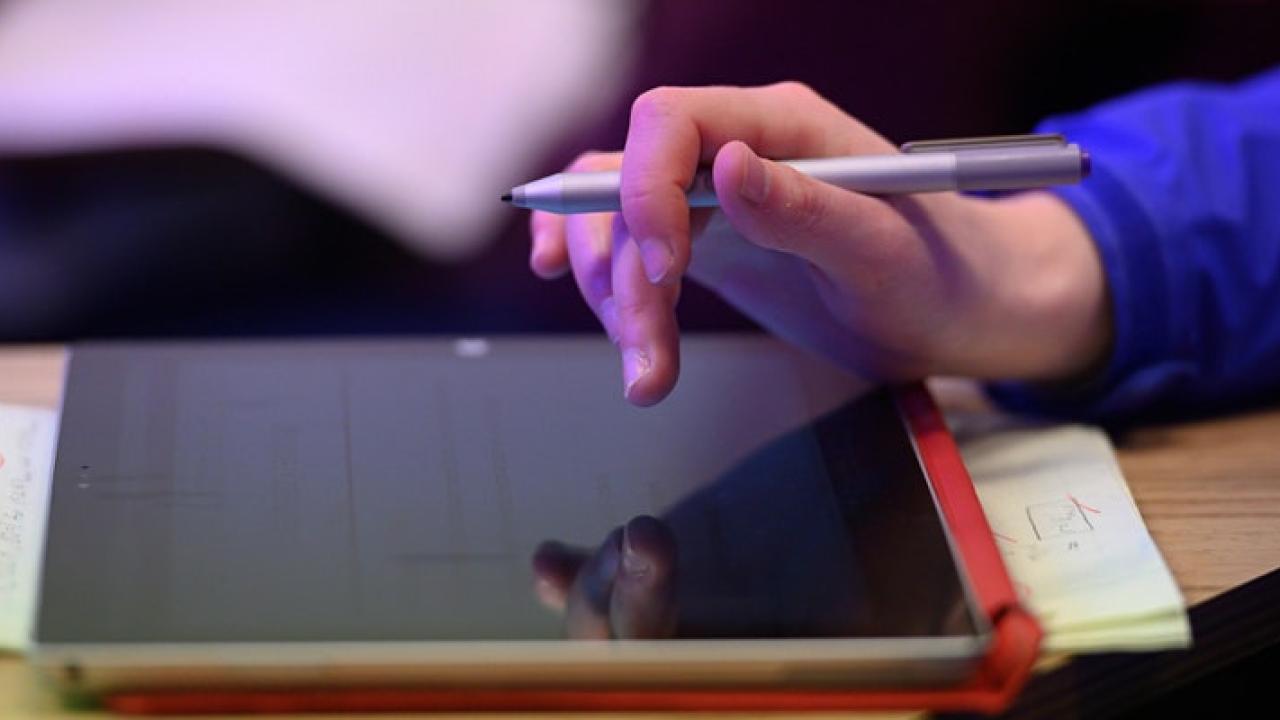 Close-up of hand working on tablet