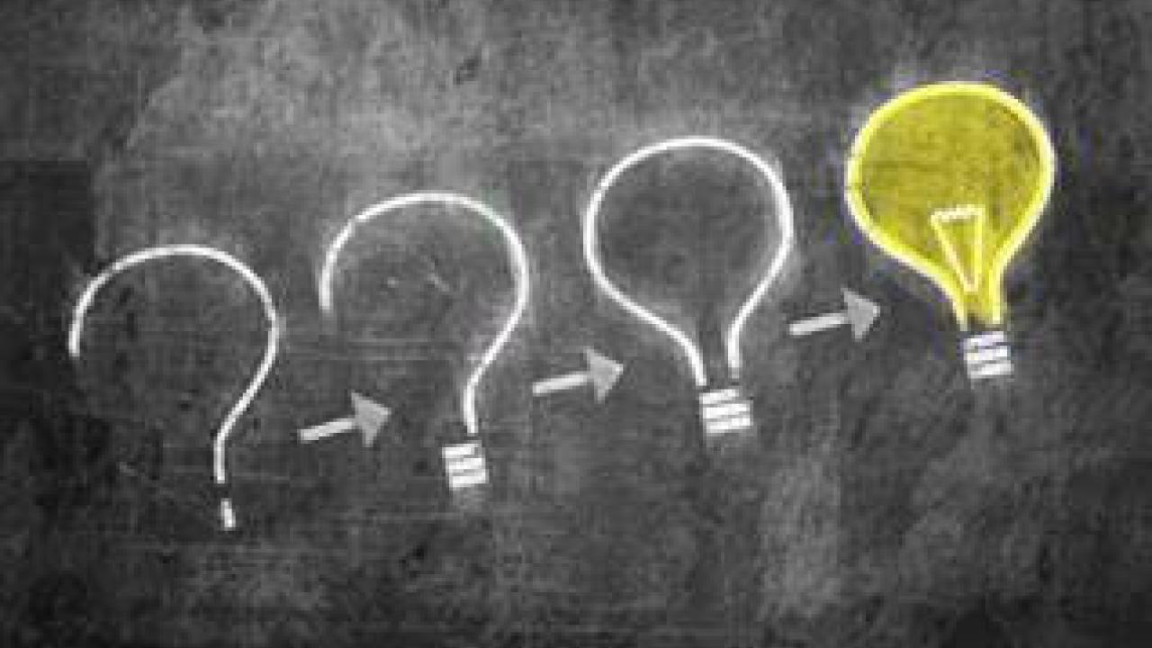 Chalkboard with question marks and a light bulb