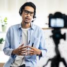 Image of instructor wearing headset and glasses speaking to camera